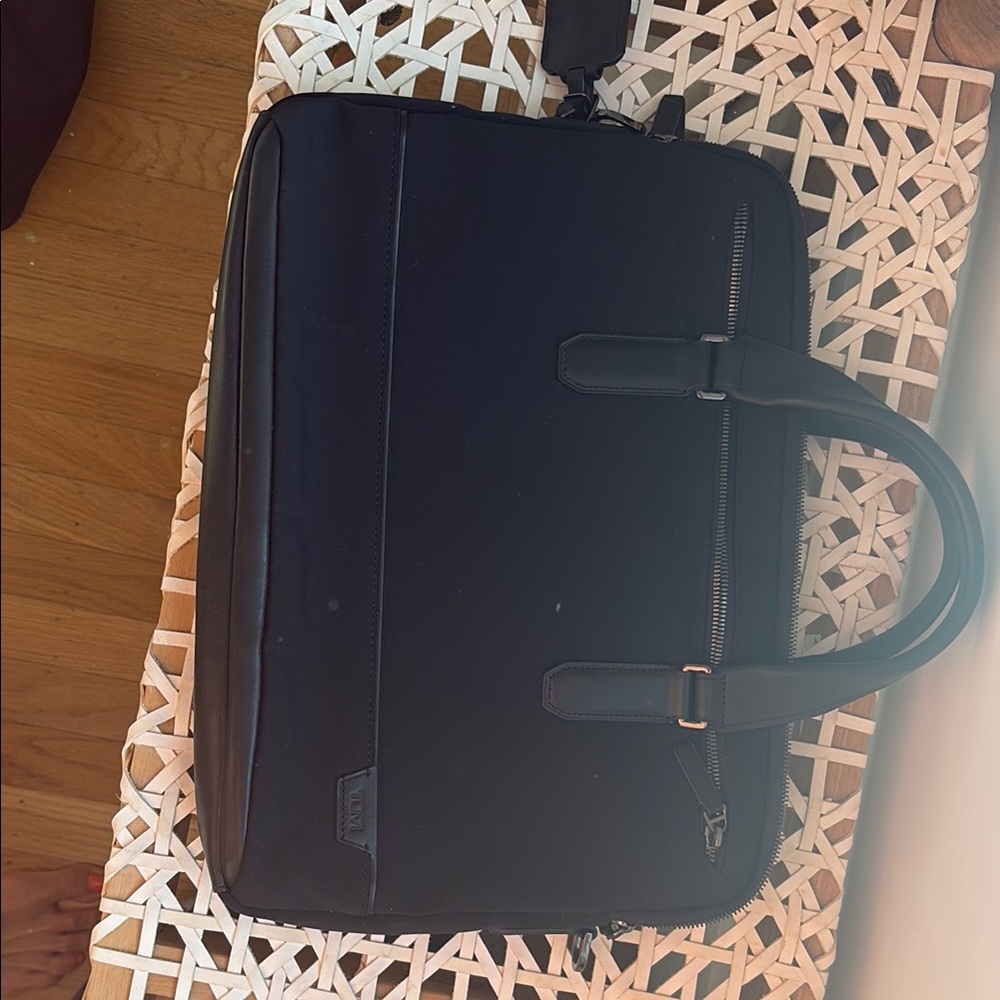 Tumi mixed media briefcase. Leather accents with fabric body. Barely used